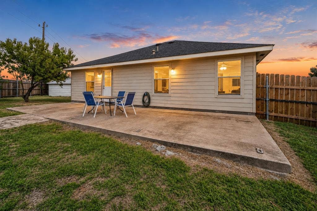 413 Bonnie Court, Anna, TX 75409 Exterior rear elevation featuring horizontal siding, a concrete patio, and a fenced backyard