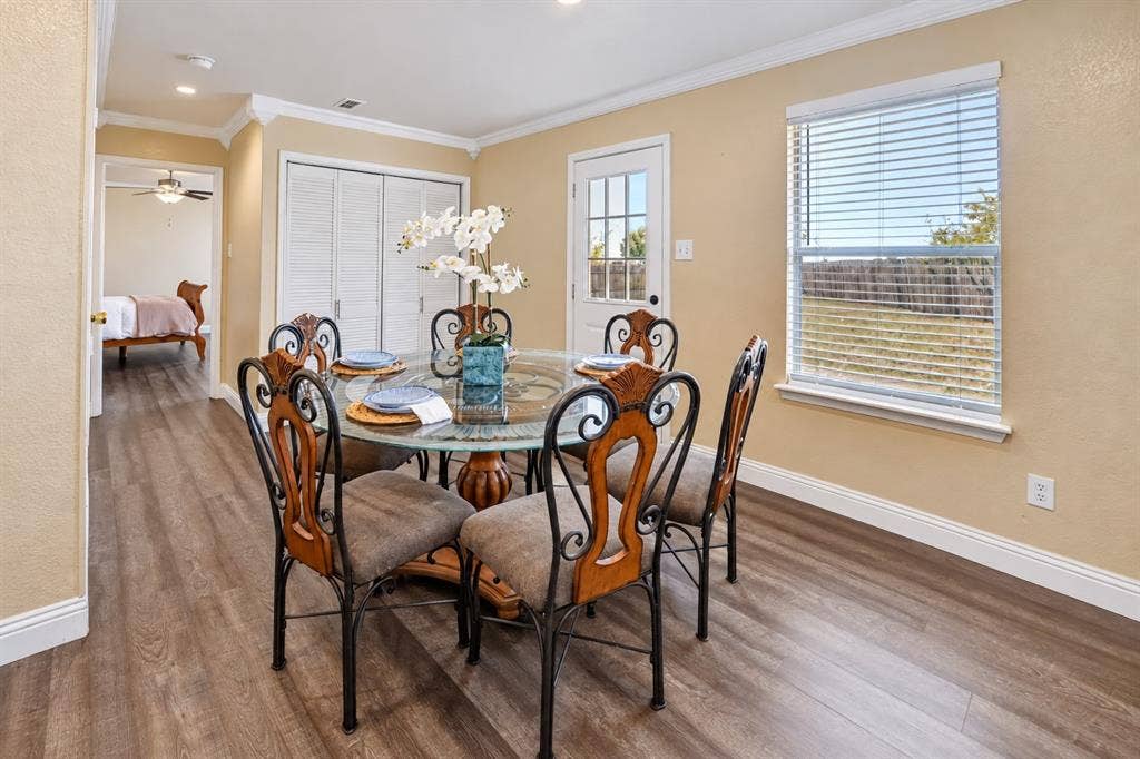413 Bonnie Court, Anna, TX 75409 Wood-finish flooring, crown molding, double-door closet with louvered panels, and a glass-paneled exterior door
