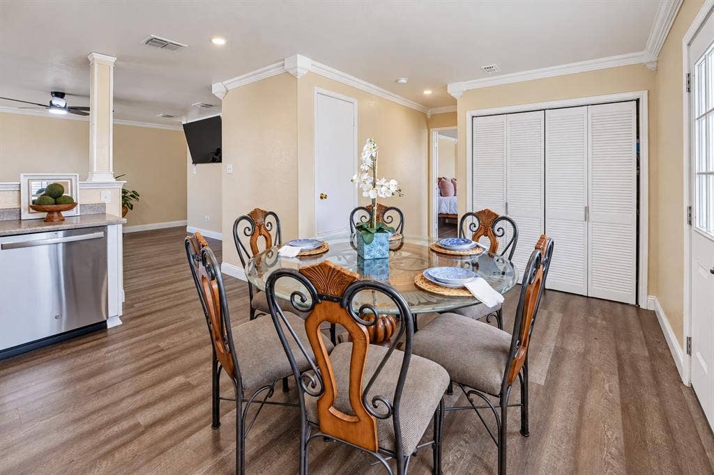 413 Bonnie Court, Anna, TX 75409 Wood-finish flooring, crown molding, stainless steel dishwasher, and louvered closet doors