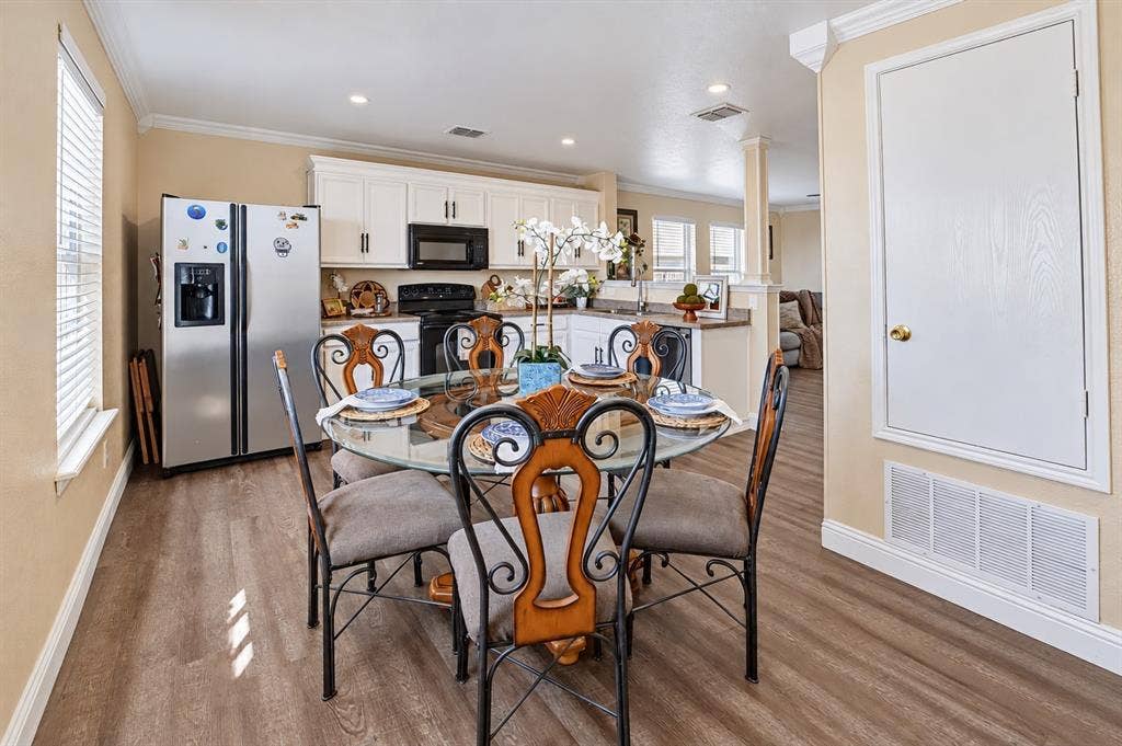 413 Bonnie Court, Anna, TX 75409 Kitchen area featuring white cabinetry, wood-finish flooring, recessed lighting, and a stainless steel refrigerator