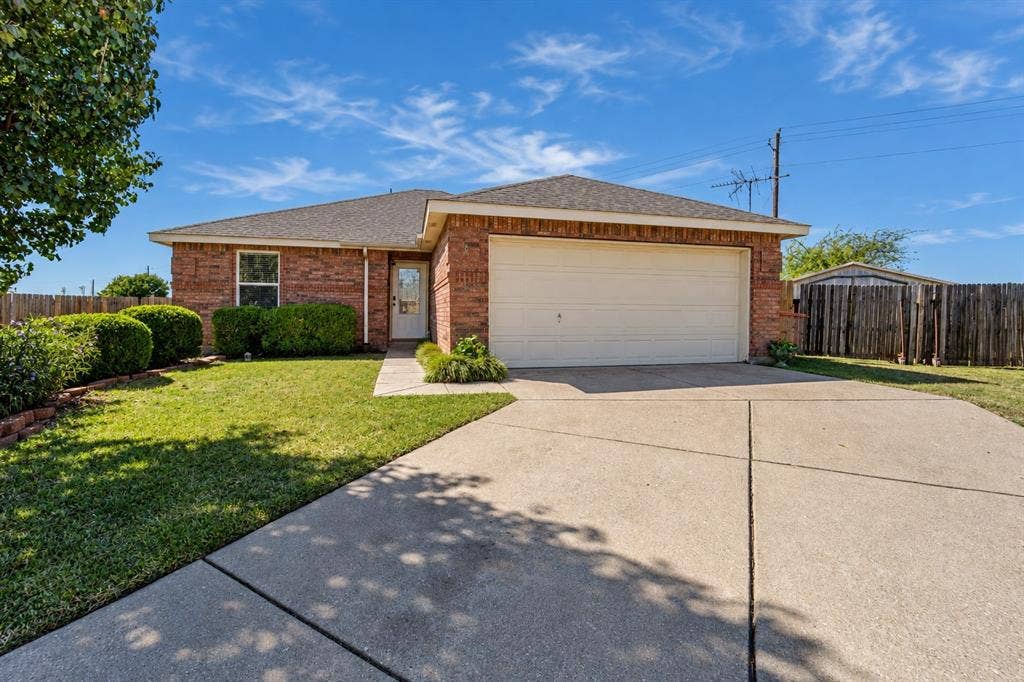 413 Bonnie Court, Anna, TX 75409 Single-story brick exterior featuring a concrete driveway, two-car garage, and manicured front lawn