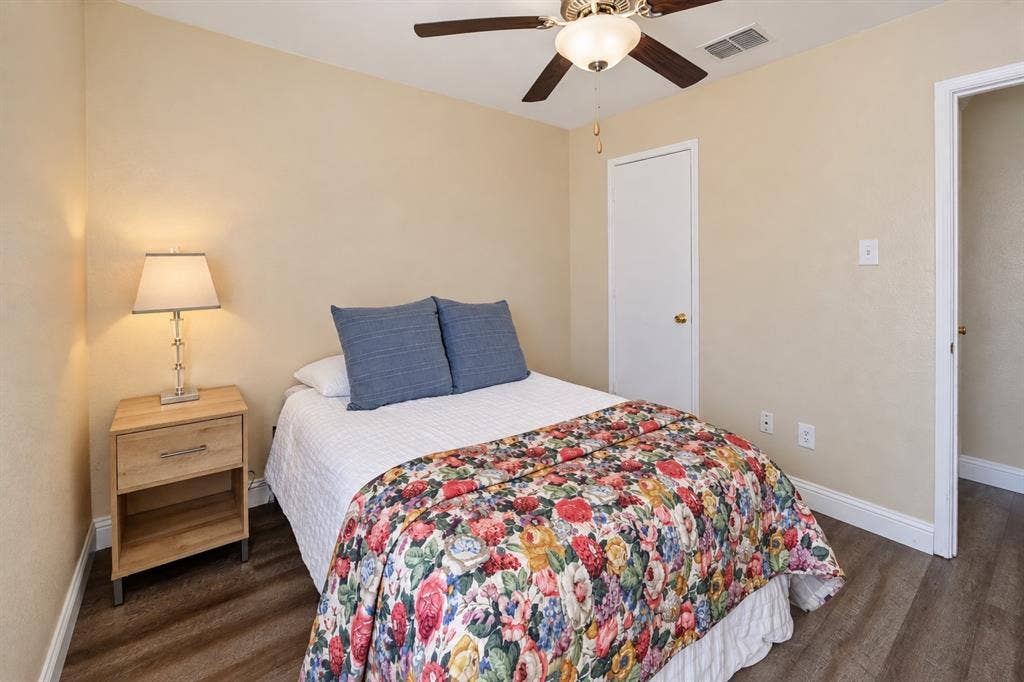 413 Bonnie Court, Anna, TX 75409 Neutral-toned walls featuring wood-finish flooring, a ceiling fan with integrated lighting, and a single-panel interior door