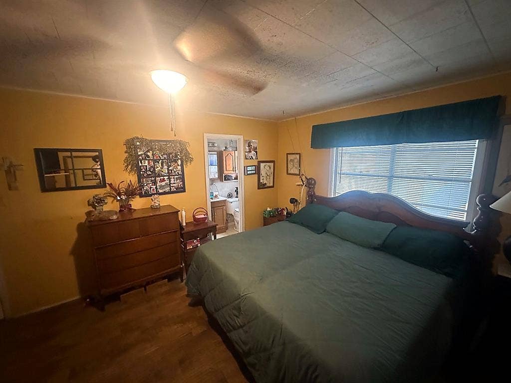 305 McKay Road, Burnet, TX 78611 Wood-finish flooring, ceiling-mounted light fixture, and window with horizontal blinds