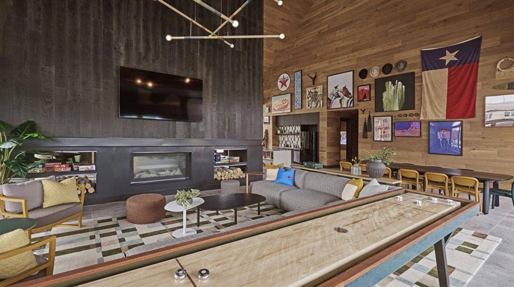 1525 FM 982, #4310, Princeton, TX 75407 Living room featuring a high ceiling, wood walls, a chandelier, a fireplace, and tile patterned floors