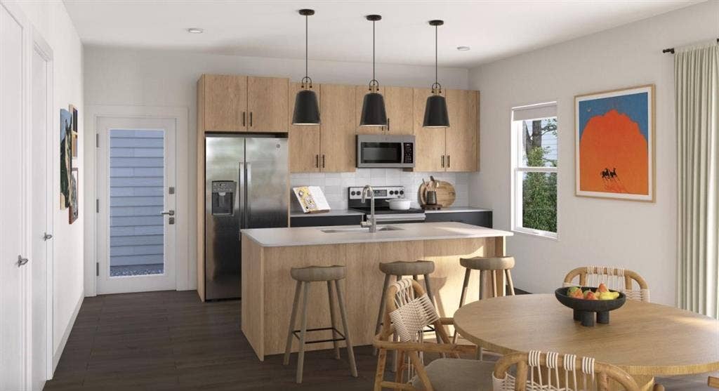 9032 Prairie Path, #BM3412, Rowlett, TX 75089 Kitchen featuring tasteful backsplash, stainless steel appliances, a kitchen island with sink, light brown cabinets, and decorative light fixtures