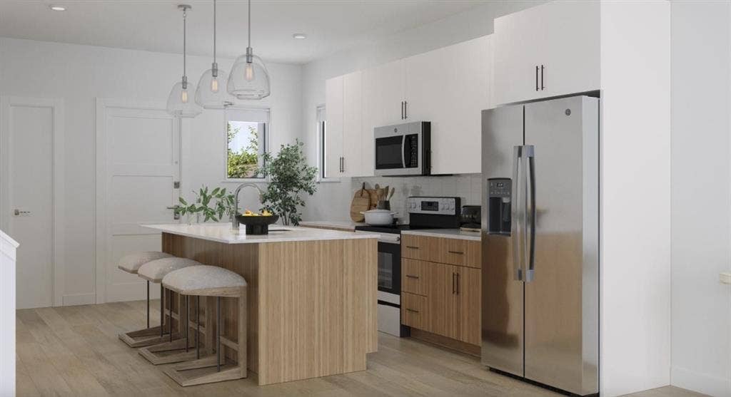 9032 Prairie Path, #BM3412, Rowlett, TX 75089 Kitchen with appliances with stainless steel finishes, a breakfast bar area, pendant lighting, tasteful backsplash, and white cabinets