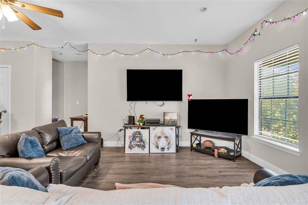 2410 S 2nd Street, #625, Waco, TX 76706 Living area featuring wood-finish flooring, neutral wall paint, and a window with horizontal blinds