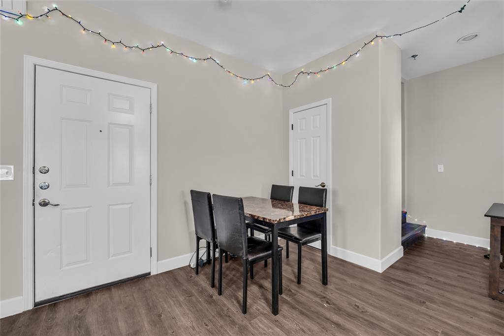 2410 S 2nd Street, #625, Waco, TX 76706 Interior space featuring wood-finish flooring, a multi-panel entry door with polished metal hardware, and a single-panel interior door
