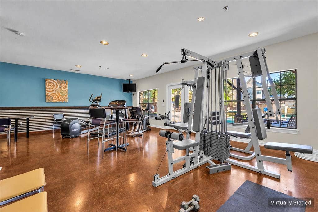 2410 S 2nd Street, #625, Waco, TX 76706 Fitness room featuring polished concrete flooring, recessed lighting, and corrugated metal wall paneling