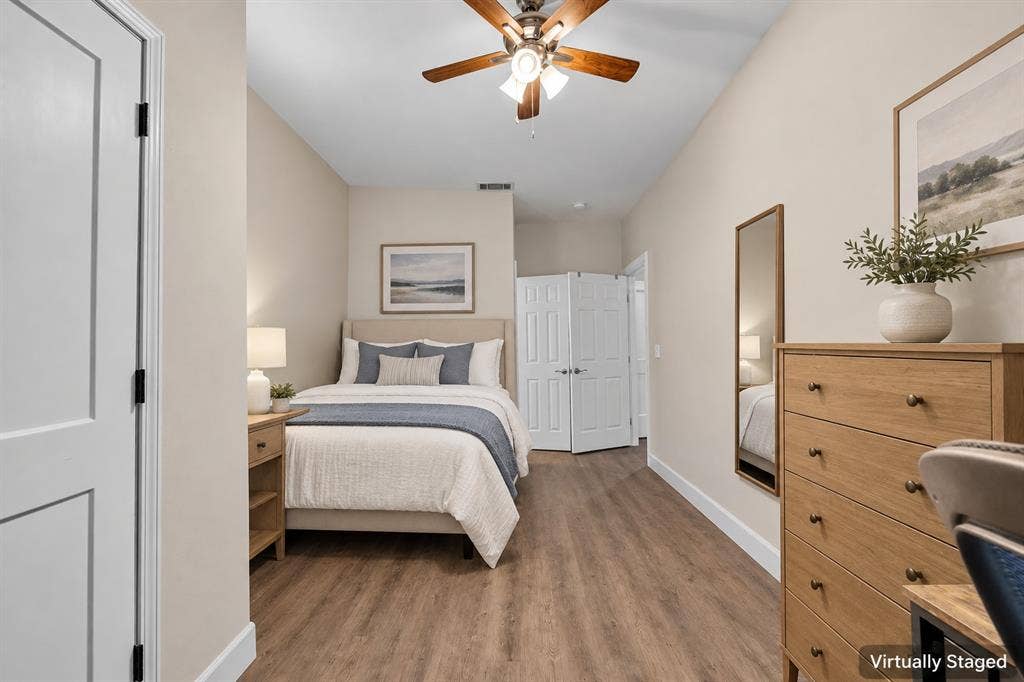 2410 S 2nd Street, #625, Waco, TX 76706 Room featuring wood-finish flooring, a ceiling fan with integrated lighting, and a double-door closet