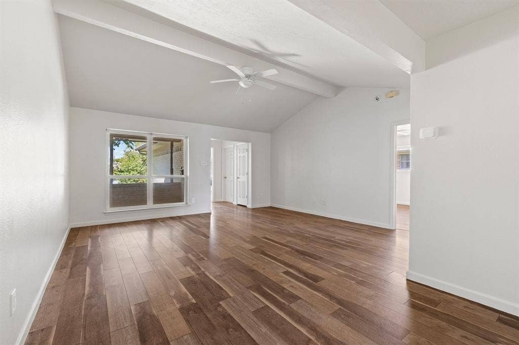 8406 Lullwater Drive, Dallas, TX 75218 Vaulted ceilings with exposed structural beams, wood-finish flooring, and a ceiling-mounted fan