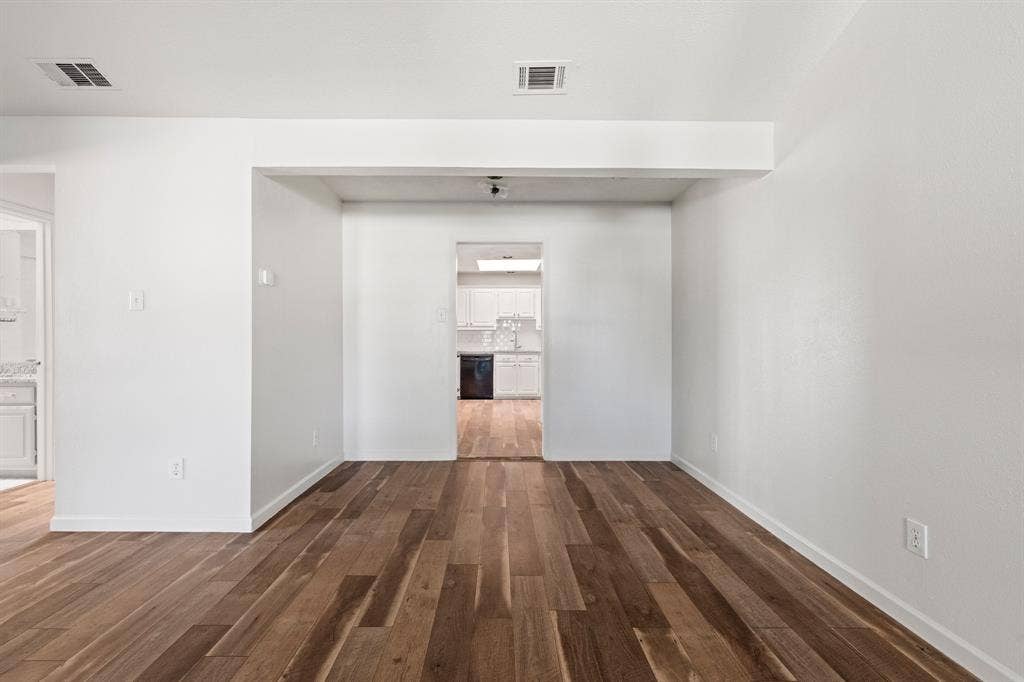 8406 Lullwater Drive, Dallas, TX 75218 Neutral interior space featuring wood-finish flooring and smooth-finish walls