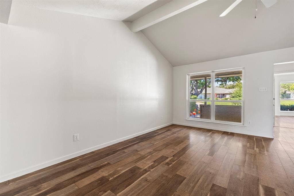 8406 Lullwater Drive, Dallas, TX 75218 Vaulted ceiling featuring exposed beams, wood-finish flooring, and a multi-pane window