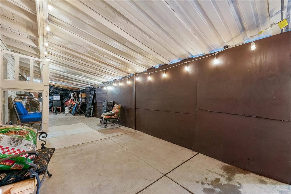 201 Glenridge Drive, Mesquite, TX 75149 Covered patio featuring a concrete floor, a sloped metal roof, and solid panel wall partitions
