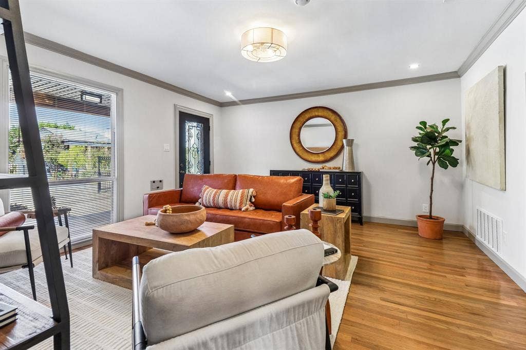 Hardwood flooring throughout, recessed lighting, crown molding, and a decorative front entry door with glass inserts