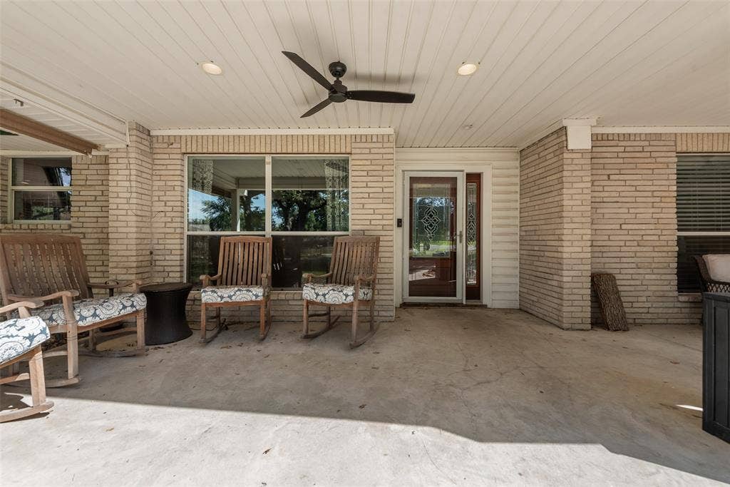 Covered patio featuring brick masonry walls, a beadboard ceiling, recessed lighting, and a ceiling fan