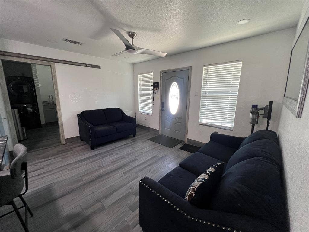 201 Darien Drive, Mesquite, TX 75149 Wood-finish flooring, recessed lighting, ceiling fan, sliding barn door, and exterior entry door with glass insert