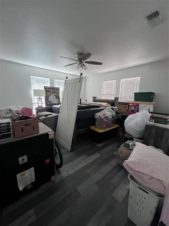 201 Darien Drive, Mesquite, TX 75149 Room featuring wood-finish flooring, a ceiling fan with integrated lighting, and multiple windows with horizontal blinds