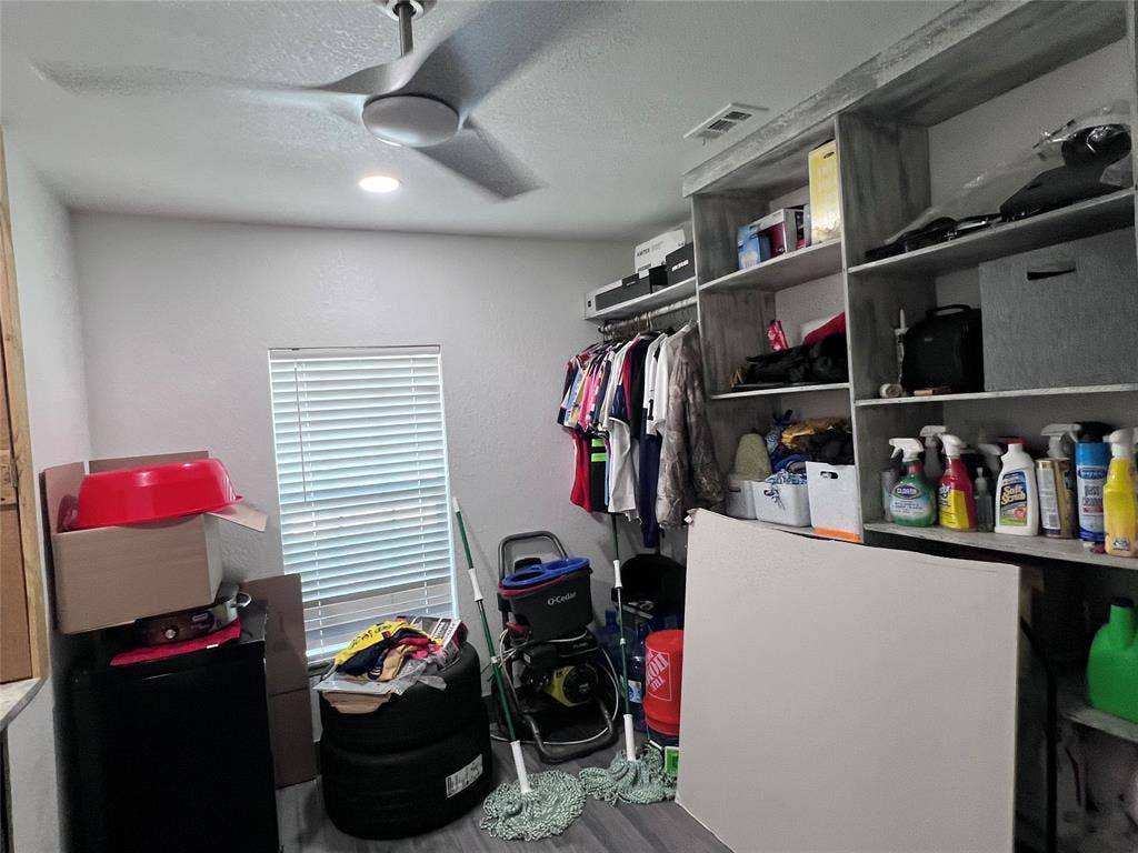 201 Darien Drive, Mesquite, TX 75149 Custom built-in shelving unit, multi-blade ceiling fan, and window with horizontal blinds
