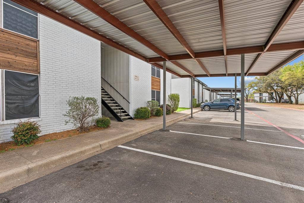 1301 W Hwy 287 ByPass, #108, Waxahachie, TX 75165 Community covered parking and walkway at The Ashton on 287. Community view, not the specific exterior or interior of this unit. Covered parking is optional; confirm availability and charges.