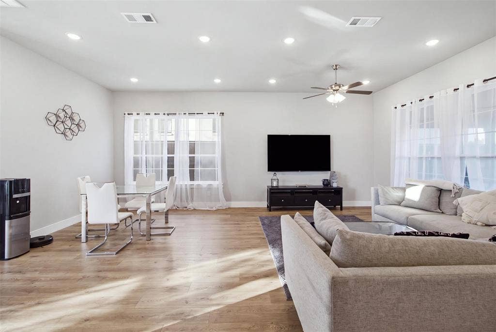 1408 Rockcliff Street, Plano, TX 75093 Open-concept living space featuring wood-finish flooring, recessed lighting, and a ceiling fan
