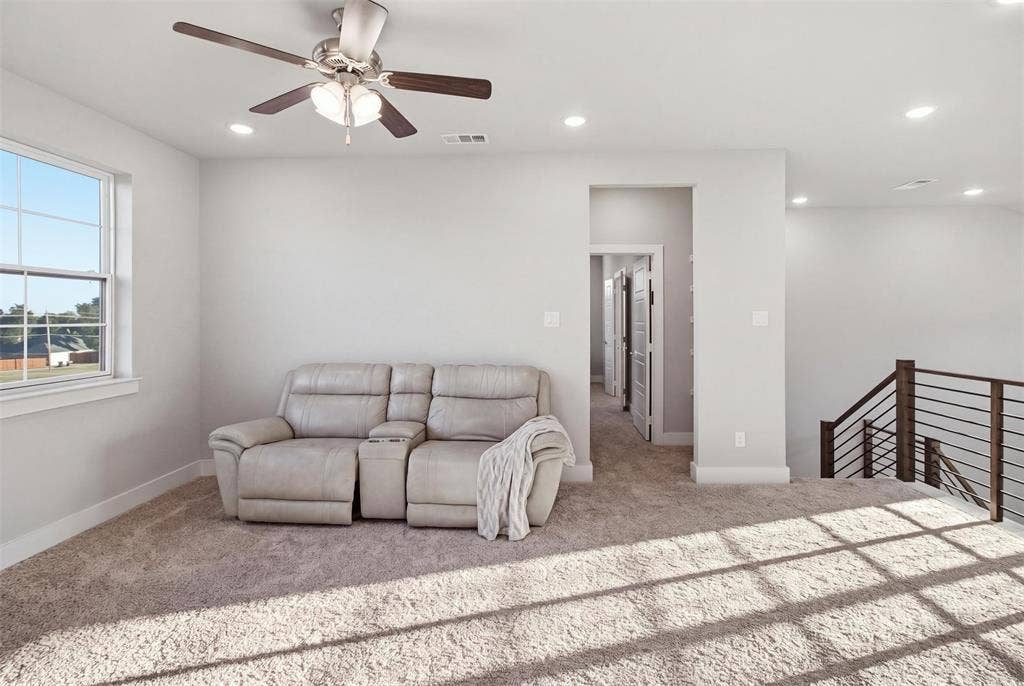 1408 Rockcliff Street, Plano, TX 75093 Neutral carpeting, recessed lighting, ceiling fan with integrated light fixture, and metal horizontal rail staircase