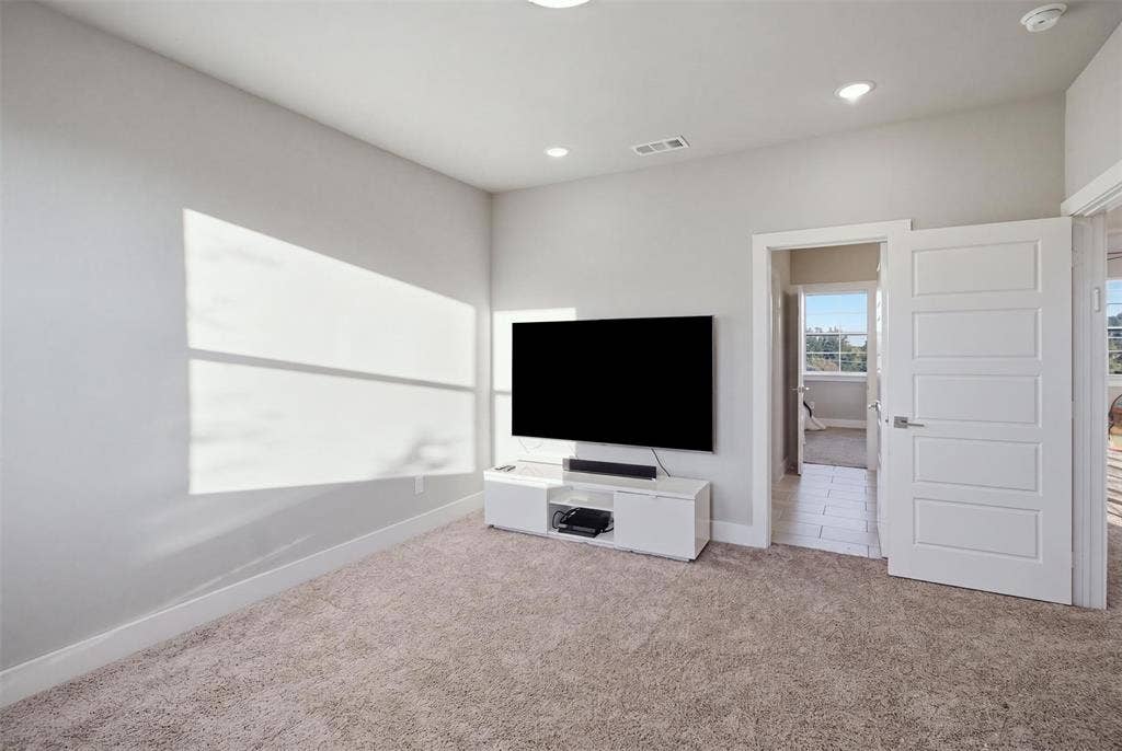 1408 Rockcliff Street, Plano, TX 75093 Neutral-toned interior space featuring recessed ceiling lighting, wall-to-wall carpeting, and a four-panel interior door