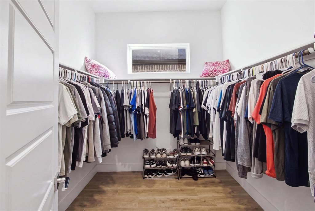 1408 Rockcliff Street, Plano, TX 75093 Walk-in closet featuring wood-finish flooring, built-in metal shelving, and a horizontal window