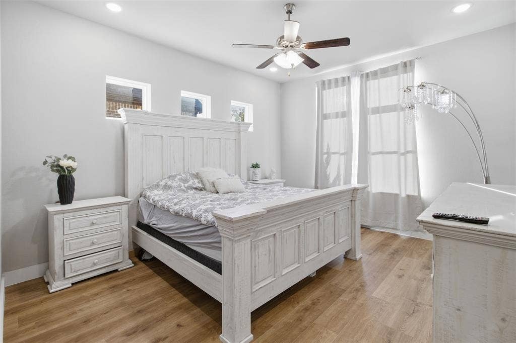 1408 Rockcliff Street, Plano, TX 75093 Wood-finish flooring, recessed lighting, ceiling fan with light kit, and multiple windows providing natural light