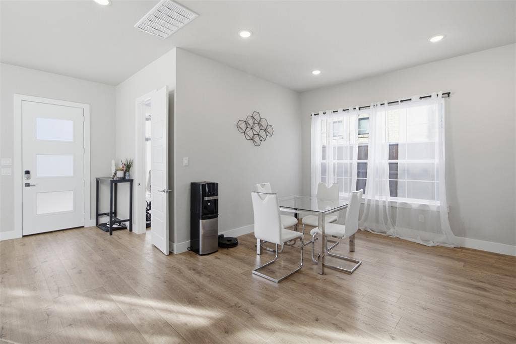 1408 Rockcliff Street, Plano, TX 75093 Wood-finish flooring, recessed lighting, and a white entry door featuring three frosted glass panels