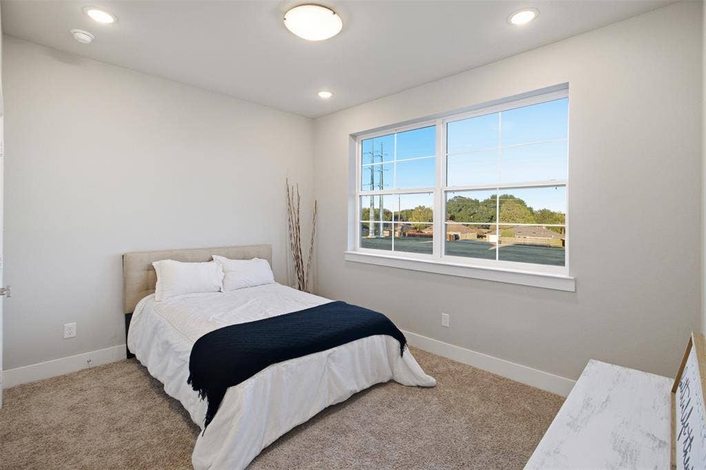 1408 Rockcliff Street, Plano, TX 75093 Neutral-toned interior featuring wall-to-wall carpeting, recessed ceiling lighting, and a large multi-pane window with a sill