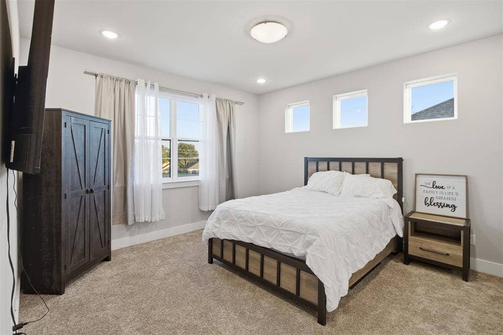 1408 Rockcliff Street, Plano, TX 75093 Neutral-toned interior featuring wall-to-wall carpeting, recessed ceiling lighting, a large double-hung window, and three high-set square windows