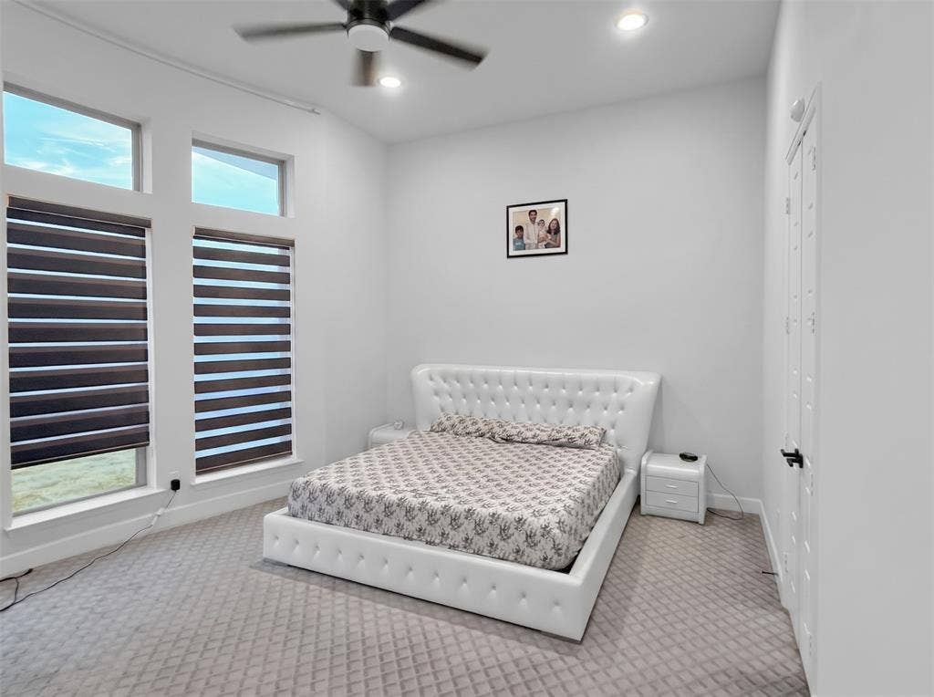 2251 Macy Way, Prosper, TX 75078 High-ceiling room featuring neutral carpeting, dual-pane windows with adjustable roller shades, recessed lighting, and a multi-speed ceiling fan