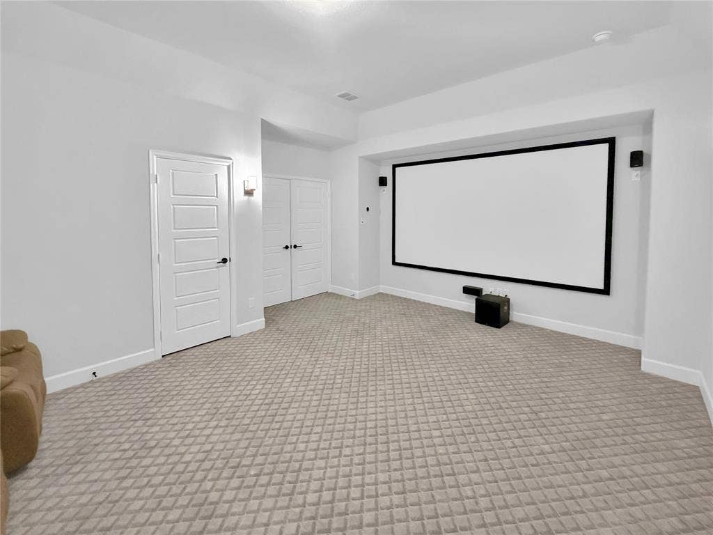 2251 Macy Way, Prosper, TX 75078 Media room featuring a built-in projector screen, wall-mounted speakers, recessed lighting, and patterned wall-to-wall carpeting