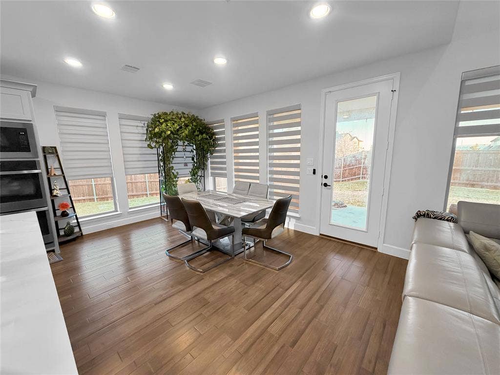 2251 Macy Way, Prosper, TX 75078 Wood-finish flooring, recessed lighting, multiple oversized windows with integrated shades, and a glass-paneled exterior door