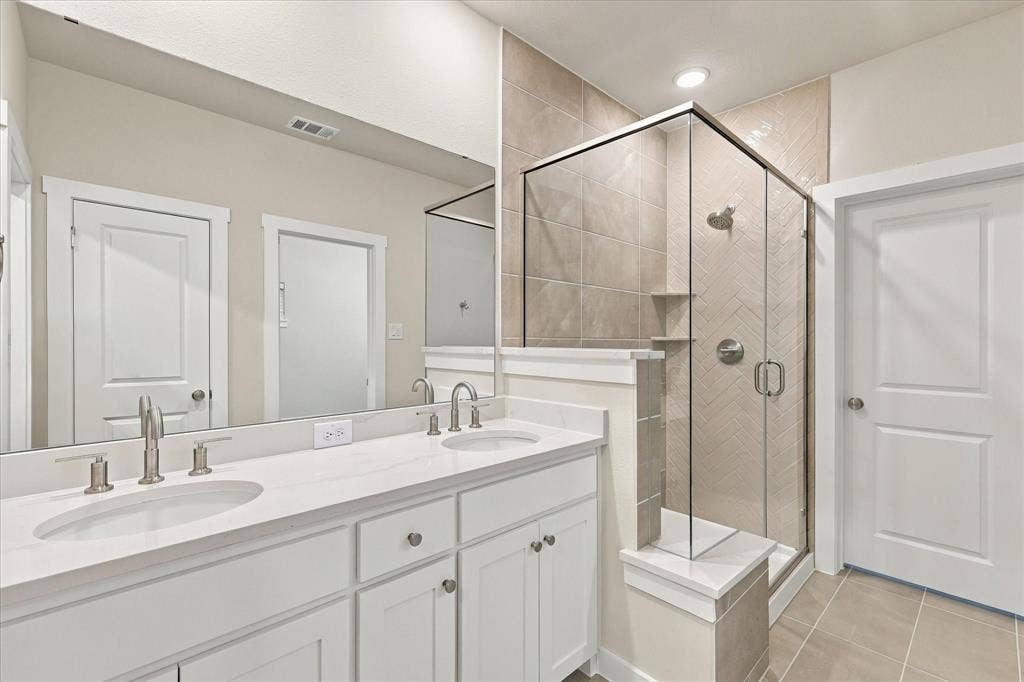 606 Nolan Lane, Wylie, TX 75098 Master bath dual sinks. Walkin shower with sitting. Wall tile up to the ceiling