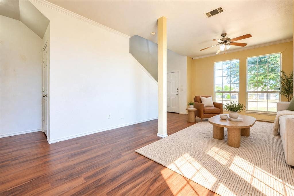 2709 Maci Court, Seagoville, TX 75159 Living space featuring wood-finish flooring, a ceiling fan with integrated lighting, dual windows, and an exposed structural column