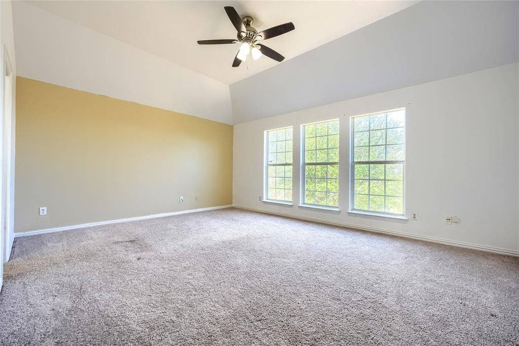 2709 Maci Court, Seagoville, TX 75159 Vaulted ceilings featuring a three-light ceiling fan and three large multi-pane windows