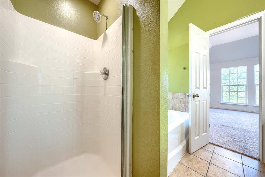 2709 Maci Court, Seagoville, TX 75159 Walk-in shower with white tile surround, chrome fixtures, soaking tub with tile deck, and ceramic tile flooring