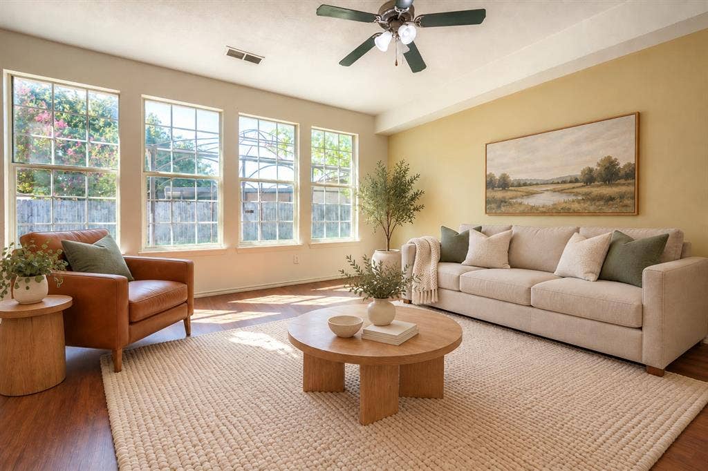 2709 Maci Court, Seagoville, TX 75159 Living area featuring wood-finish flooring, a tray ceiling with a mounted light fixture and fan, and expansive grid-pane windows