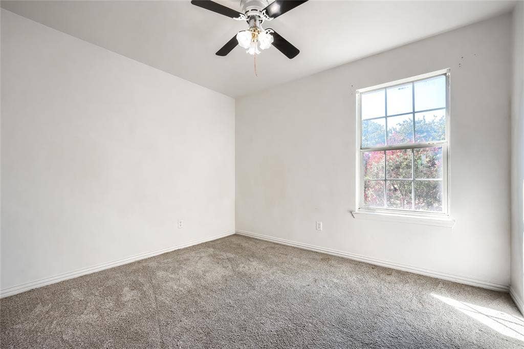 2709 Maci Court, Seagoville, TX 75159 Neutral-toned wall-to-wall carpeting, multi-pane window with natural light, and ceiling-mounted light fixture with fan