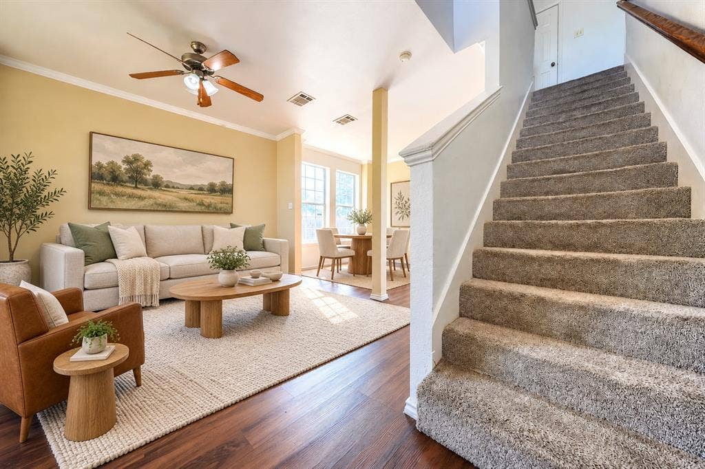 2709 Maci Court, Seagoville, TX 75159 Interior featuring wood-finish flooring, carpeted stairs with a wooden handrail, and a ceiling fan with integrated lighting