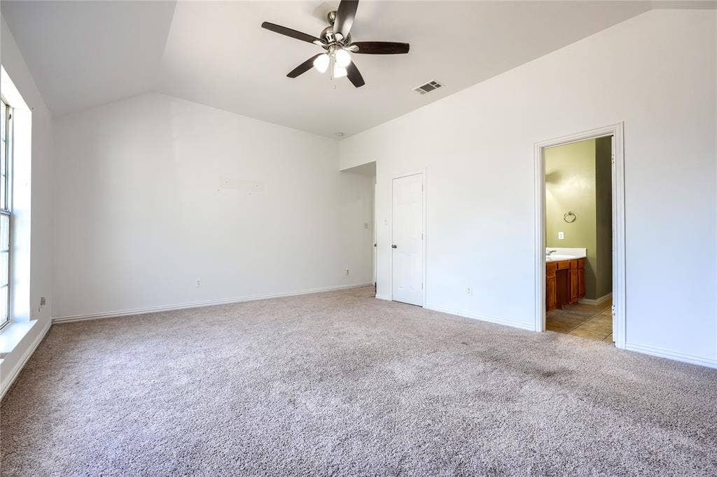 2709 Maci Court, Seagoville, TX 75159 Vaulted ceiling featuring a central multi-blade ceiling fan, wall-to-wall carpeting, and a tall rectangular window