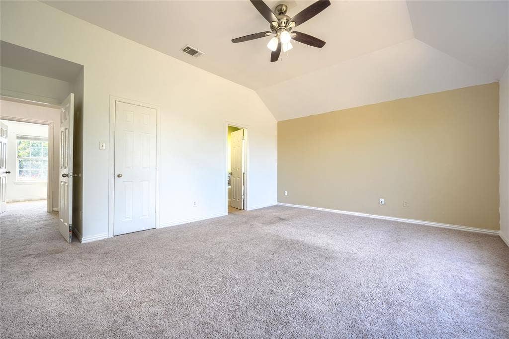 2709 Maci Court, Seagoville, TX 75159 Vaulted ceiling featuring a central multi-blade ceiling fan with integrated light kit, complemented by wall-to-wall carpeting and neutral interior wall finishes