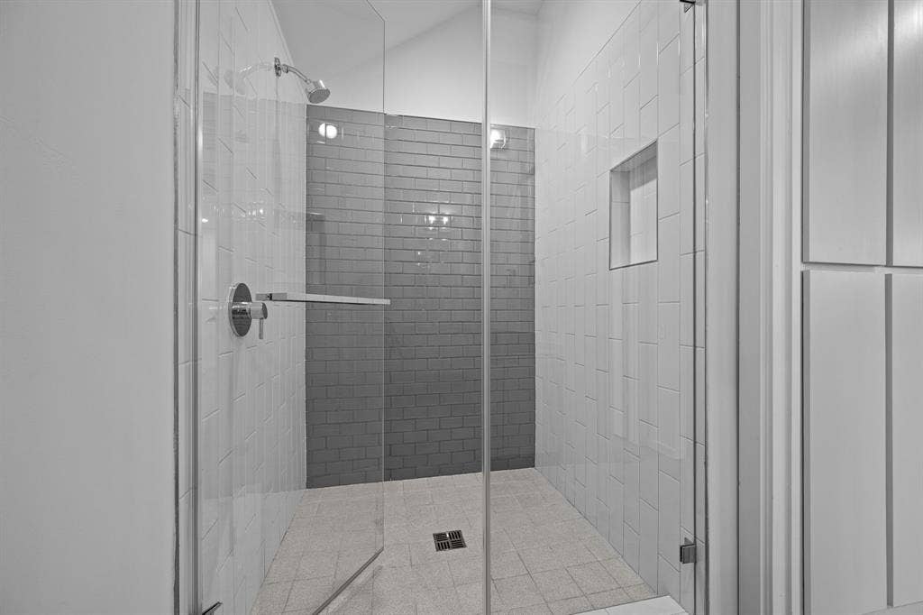 A glass-enclosed walk-in shower completes the full bath on the main level.