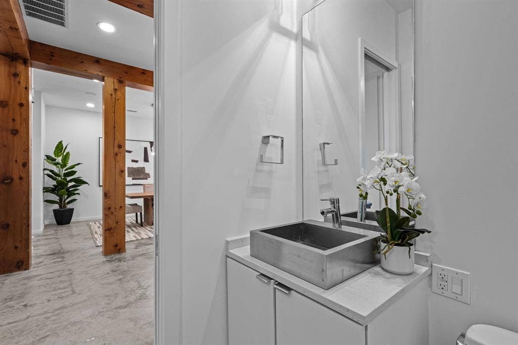A sculptural vessel sink adds a distinctive touch to the downstairs bath.