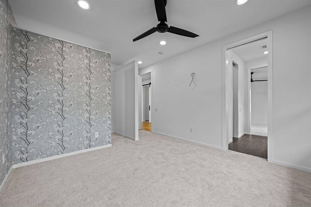 A fourth bedroom with an accent wall and shared bath access offers room for guests, work, or everyday living.
