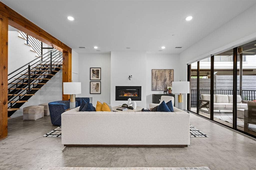 A modern fireplace anchors the living room, creating an inviting place to settle in.