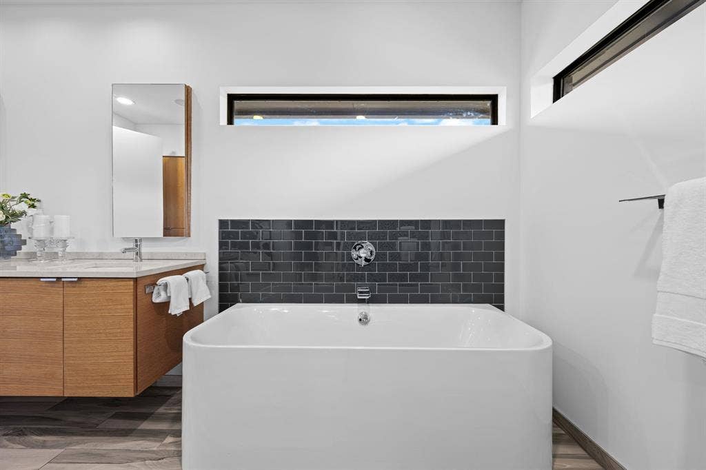 A freestanding soaking tub invites a slower pace at the end of the day.