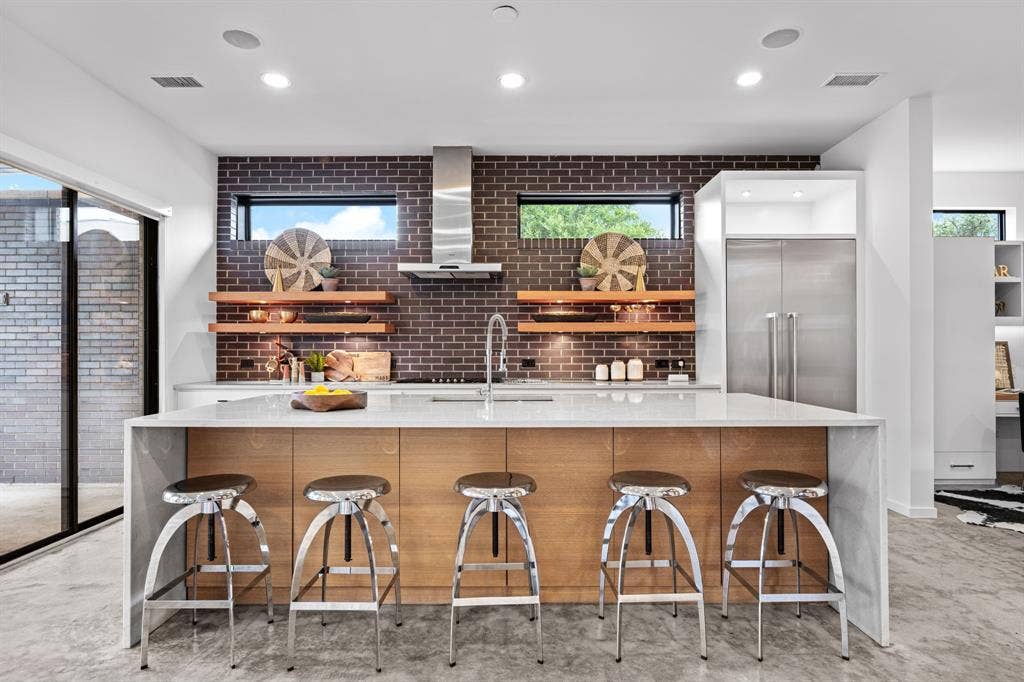 The kitchen’s generous island brings cooking, conversation, and gathering together.